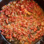 white wine deglazing a pan with sun dried tomatoes, shallots, and minced garlic