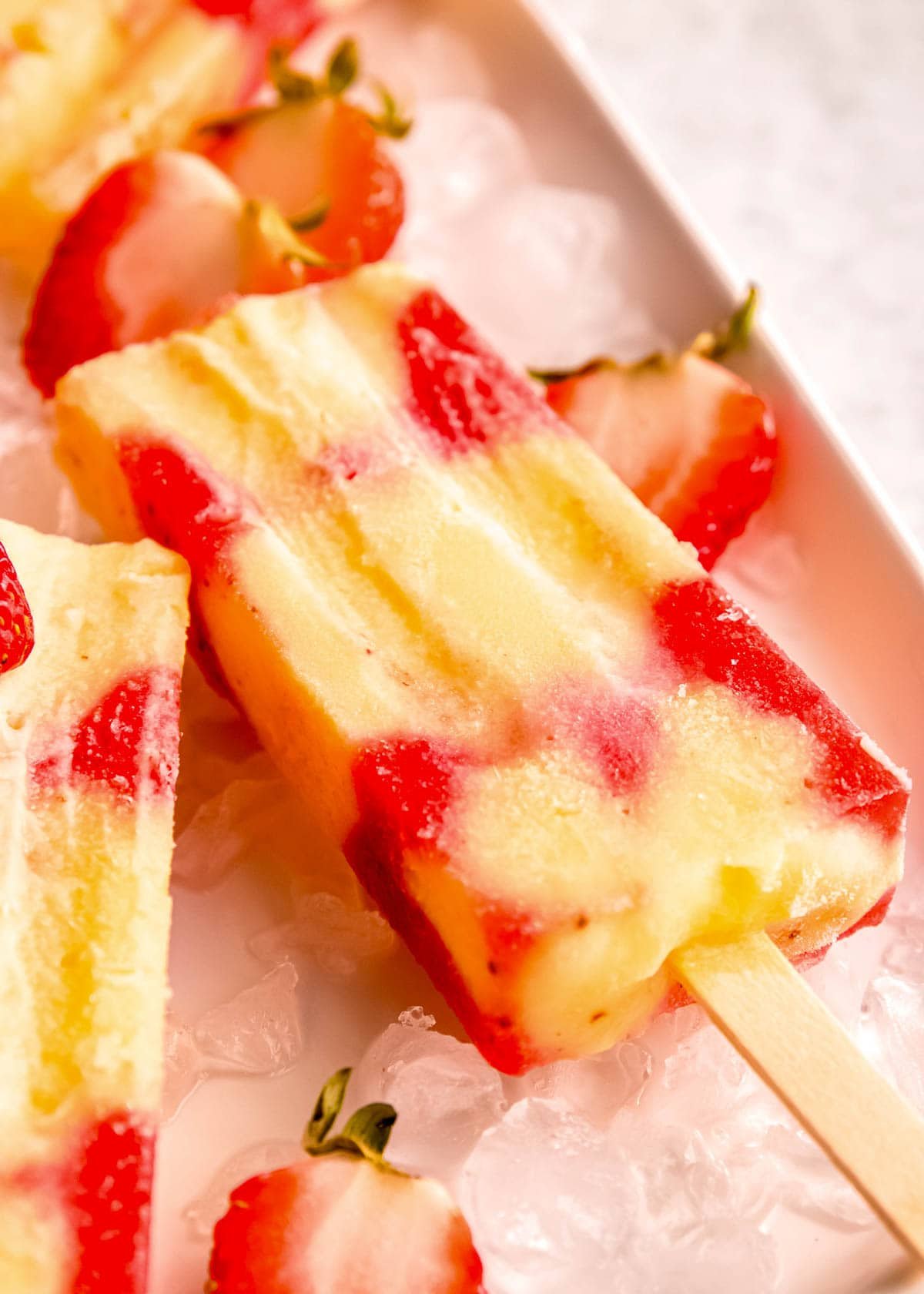frozen strawberry puree vanilla pudding popsicle on ice