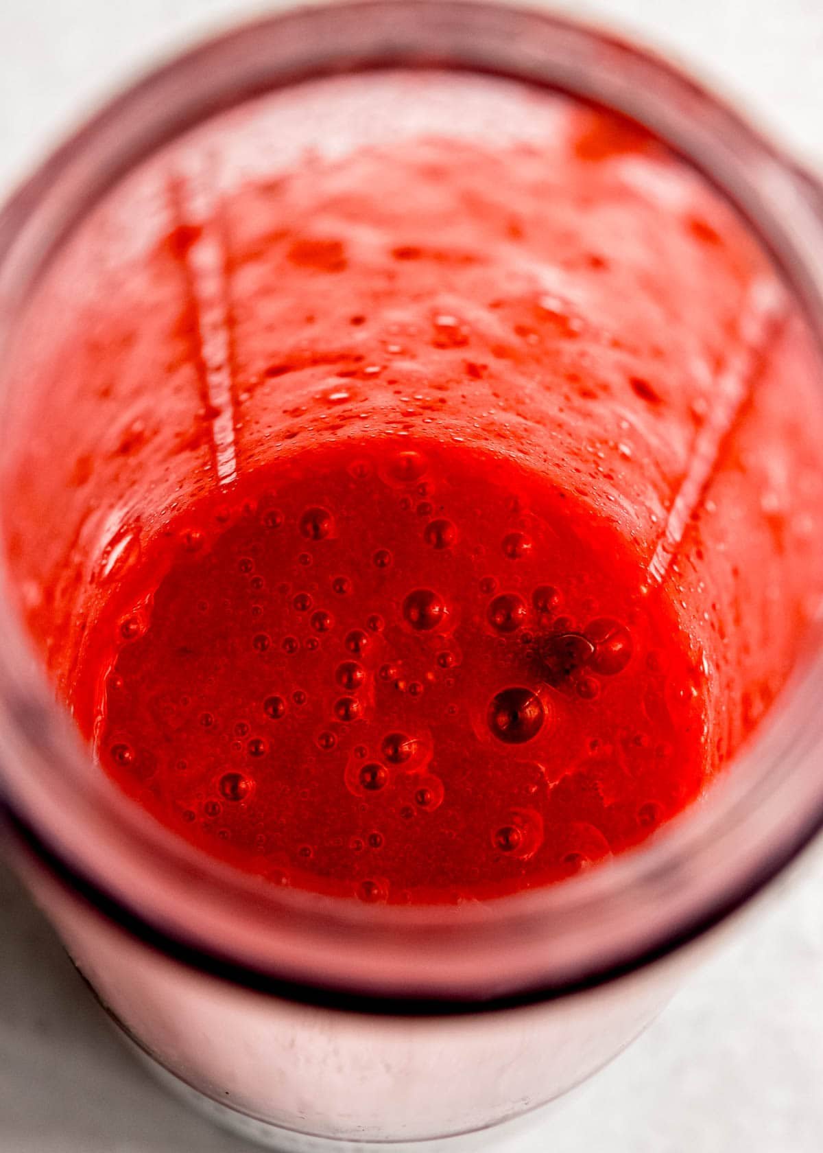 strawberries pureed with sugar in a blender cup