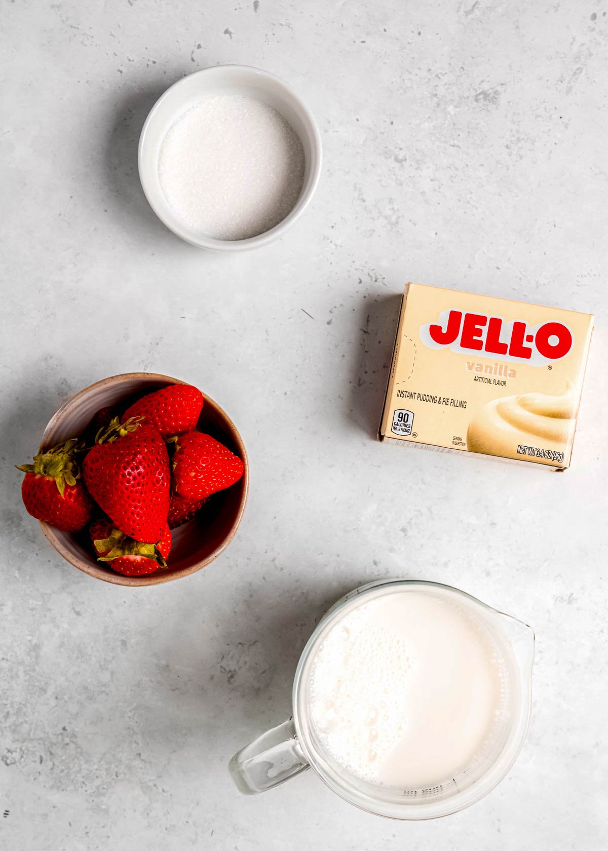 ingredients needed for strawberry popsicles on a countertop