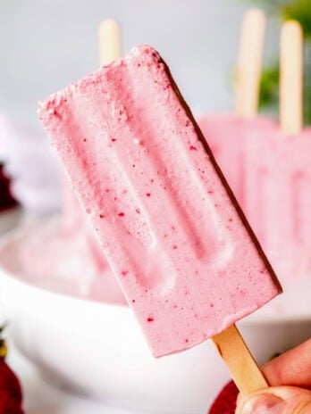 A creamy strawberry pudding pop on a stick