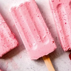 frozen strawberry pudding pops on a countertop