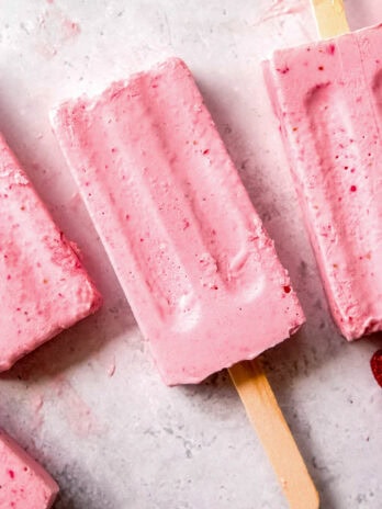 frozen strawberry pudding pops on a countertop