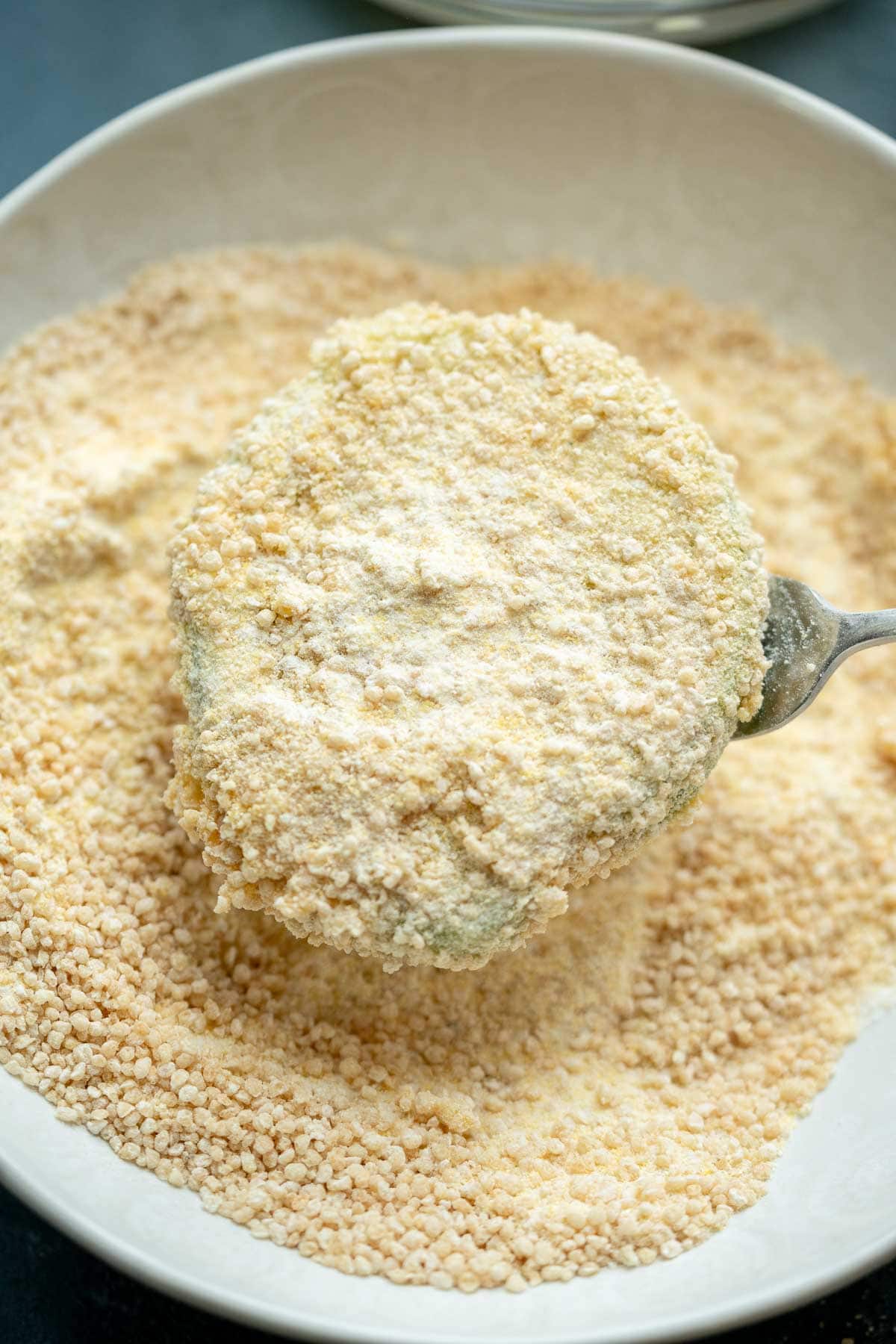 a green tomato slice covered in cornmeal breading