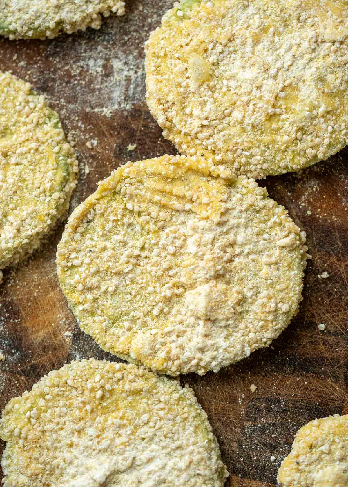 several slices of green tomato coated in a cornmeal breading