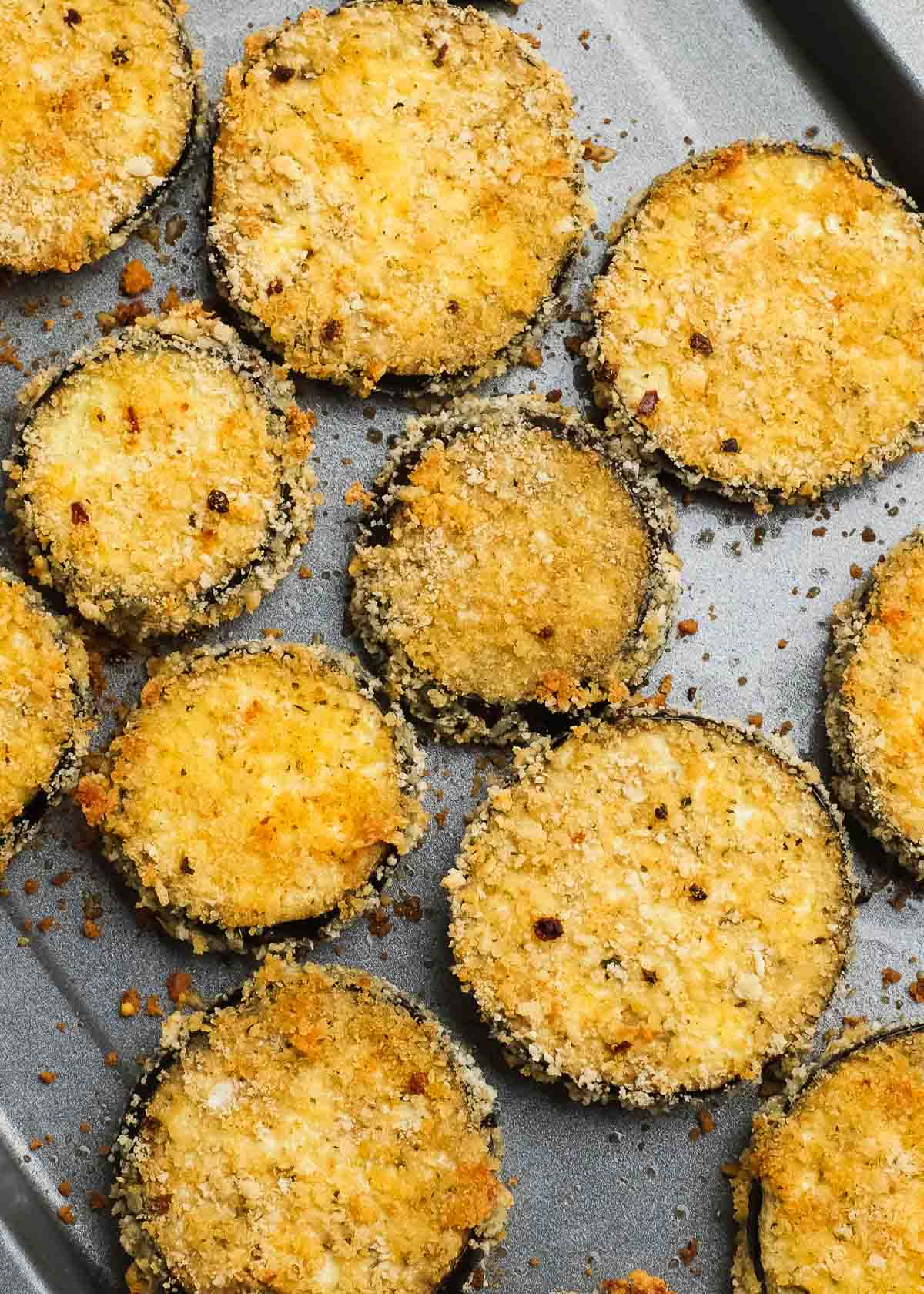 golden brown and crisp zucchini slices on a baking sheet