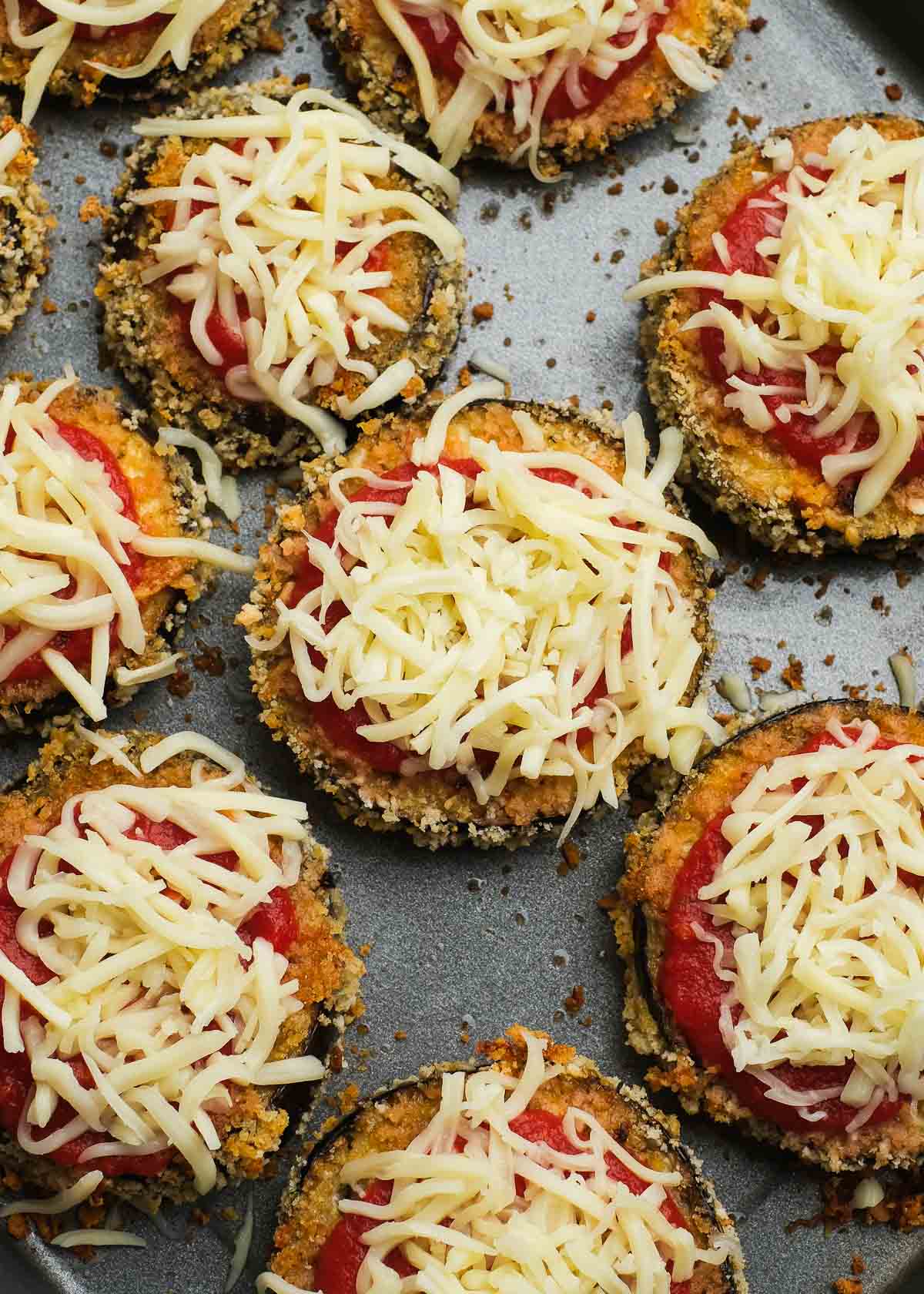 shredded mozzarella and marinara sauce atop crispy zucchini slices