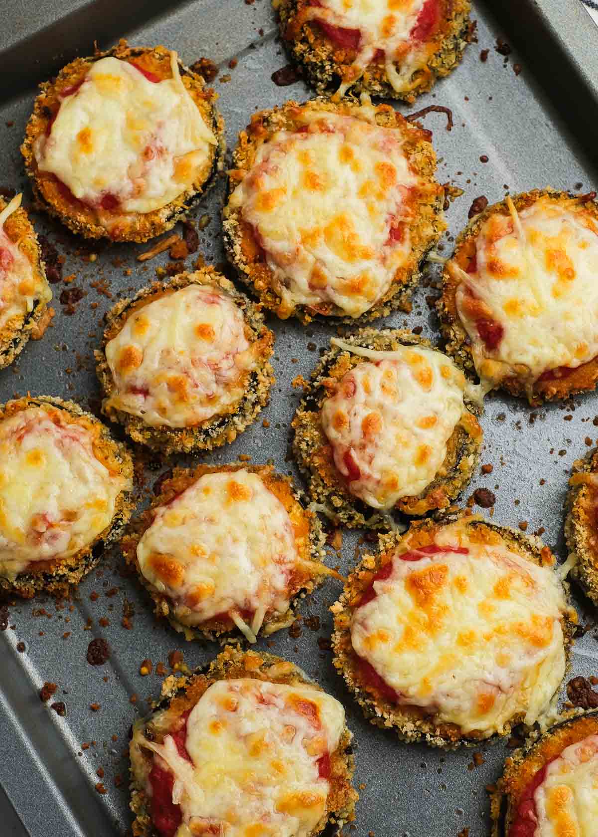 overhead shot of zucchini parmesan slices on a baking pan