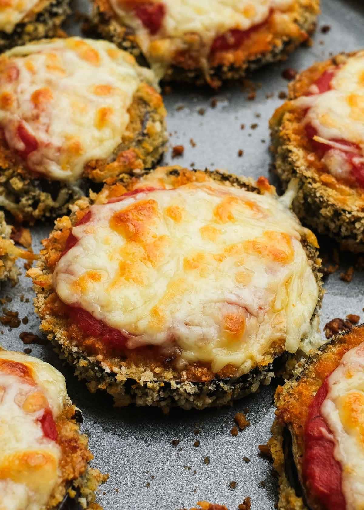 closeup shot showing melty mozzarella and creamy marinara sauce over crispy breading for the perfect zucchini parmesan