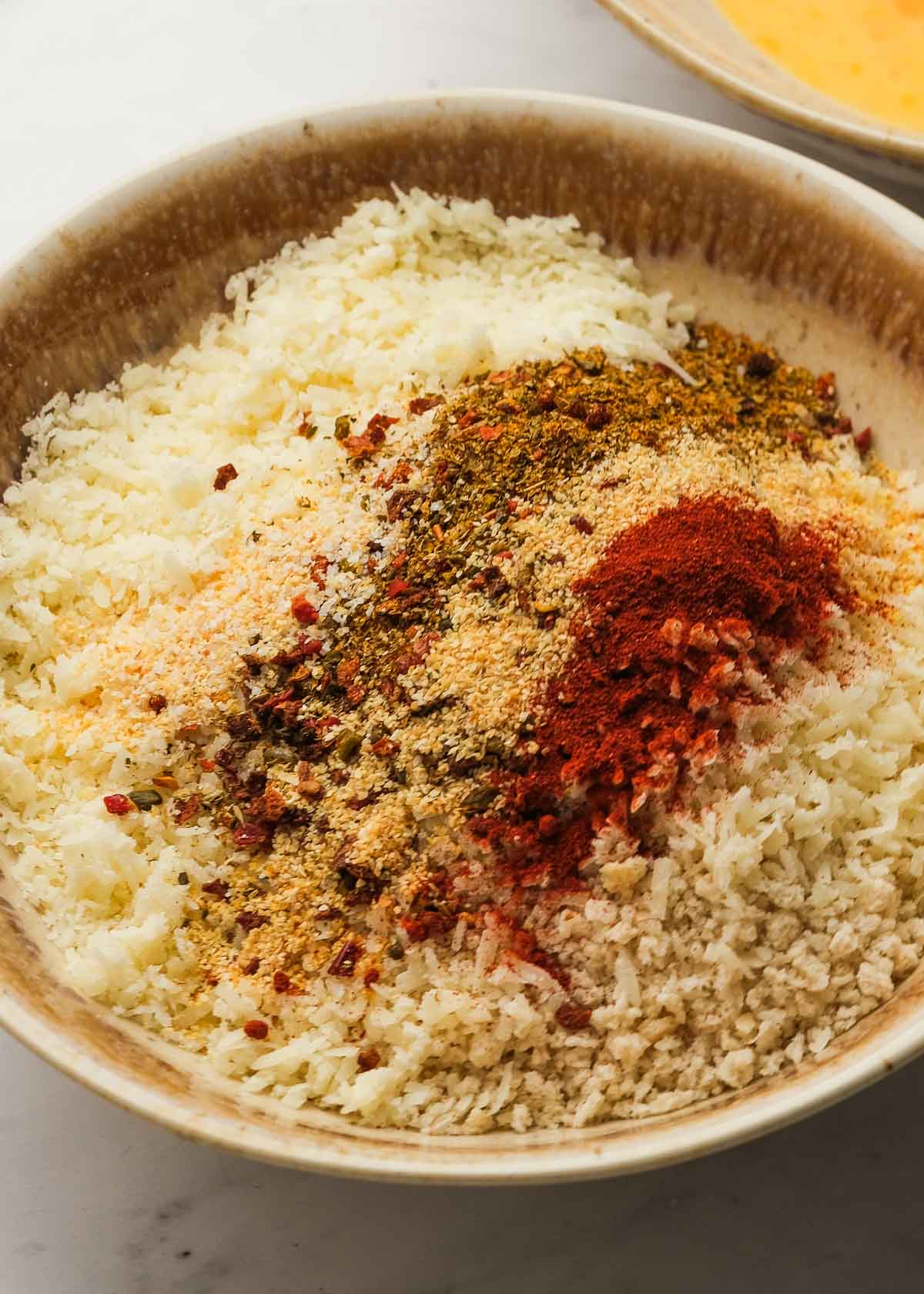 seasonings, parmesan, and panko breadcrumbs in a bowl for zucchini parmesan breading