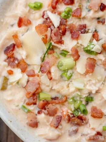 Crack Chicken Soup in a bowl topped with bacon, cheese, and green onions
