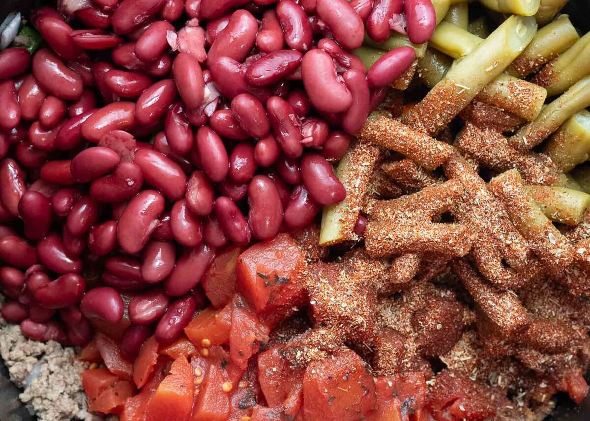 pinto beans, seasonings, carrots, green beans, and tomatoes added to a beef soup base