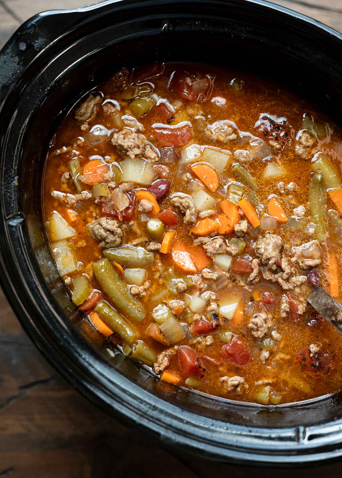 a large slow cooker filled with cowboy soup