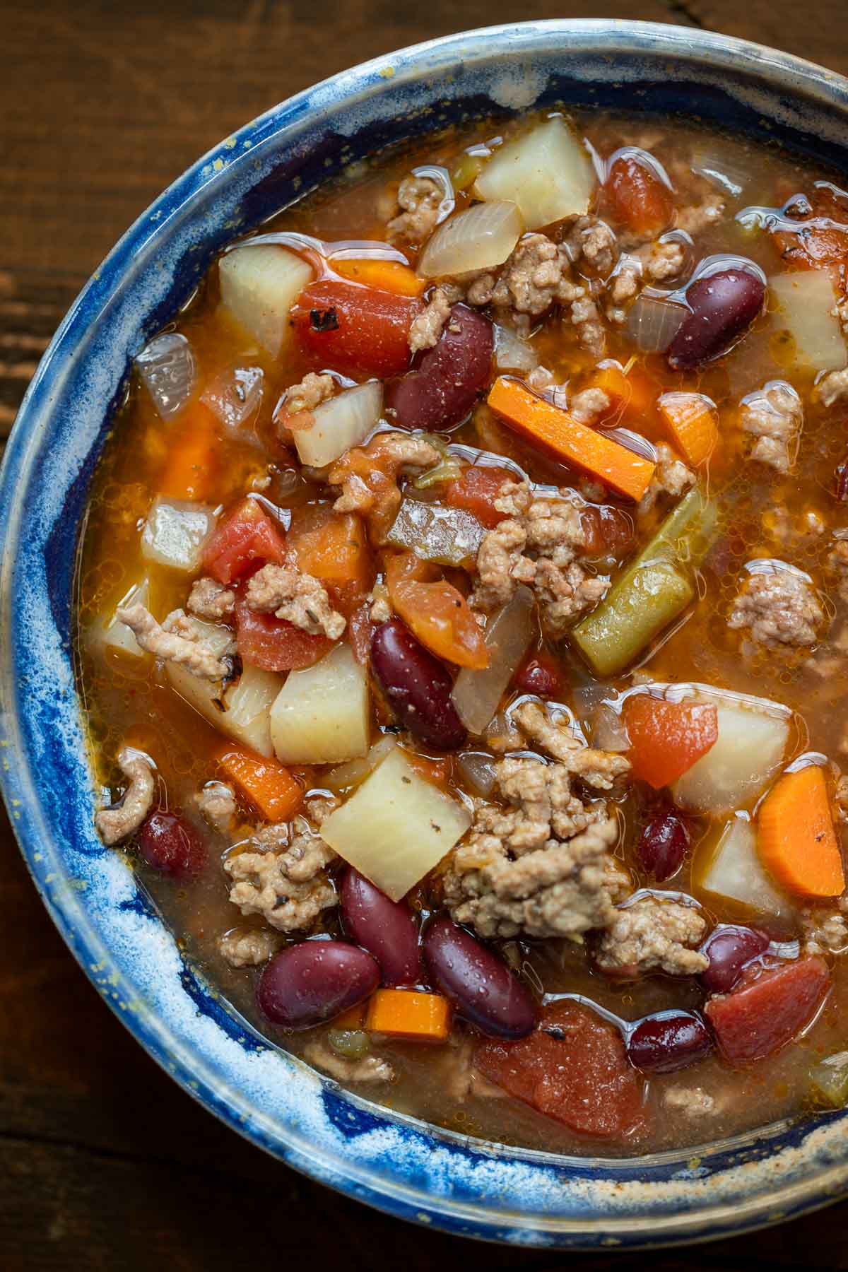 a blue bowl full of crockpot cowboy soup