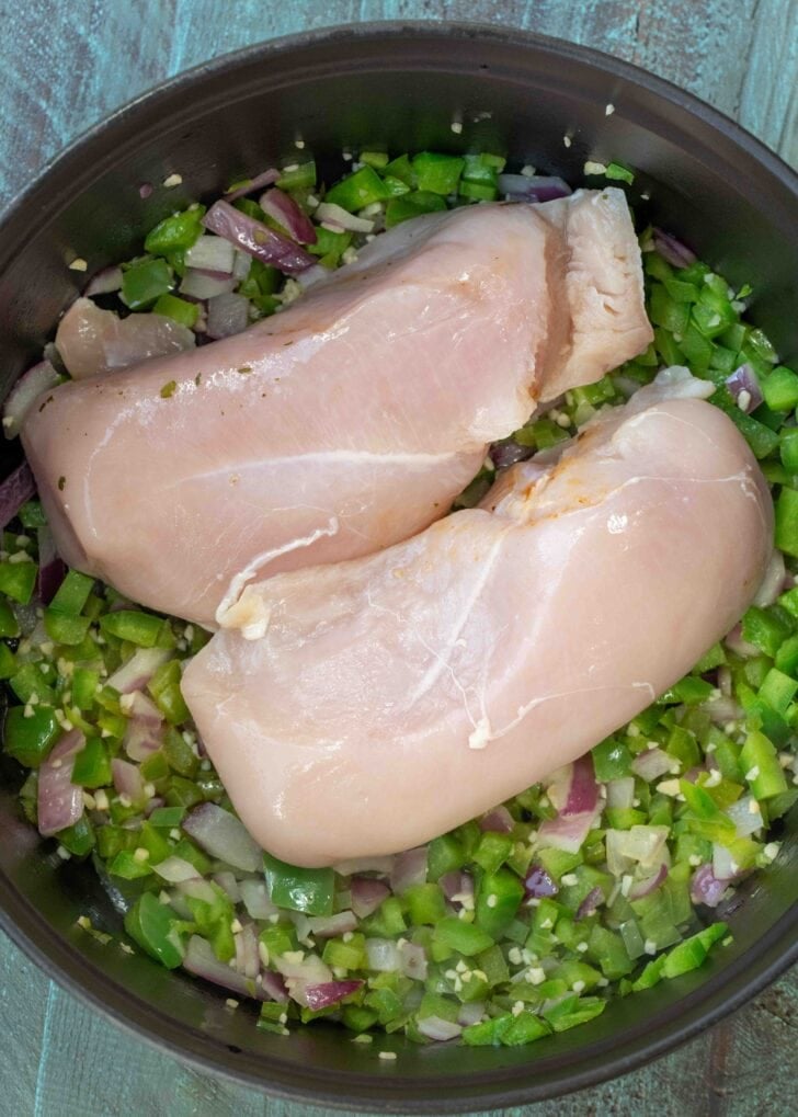 chicken breasts added atop sauteed bell peppers, jalapenos, red onions, and garlic