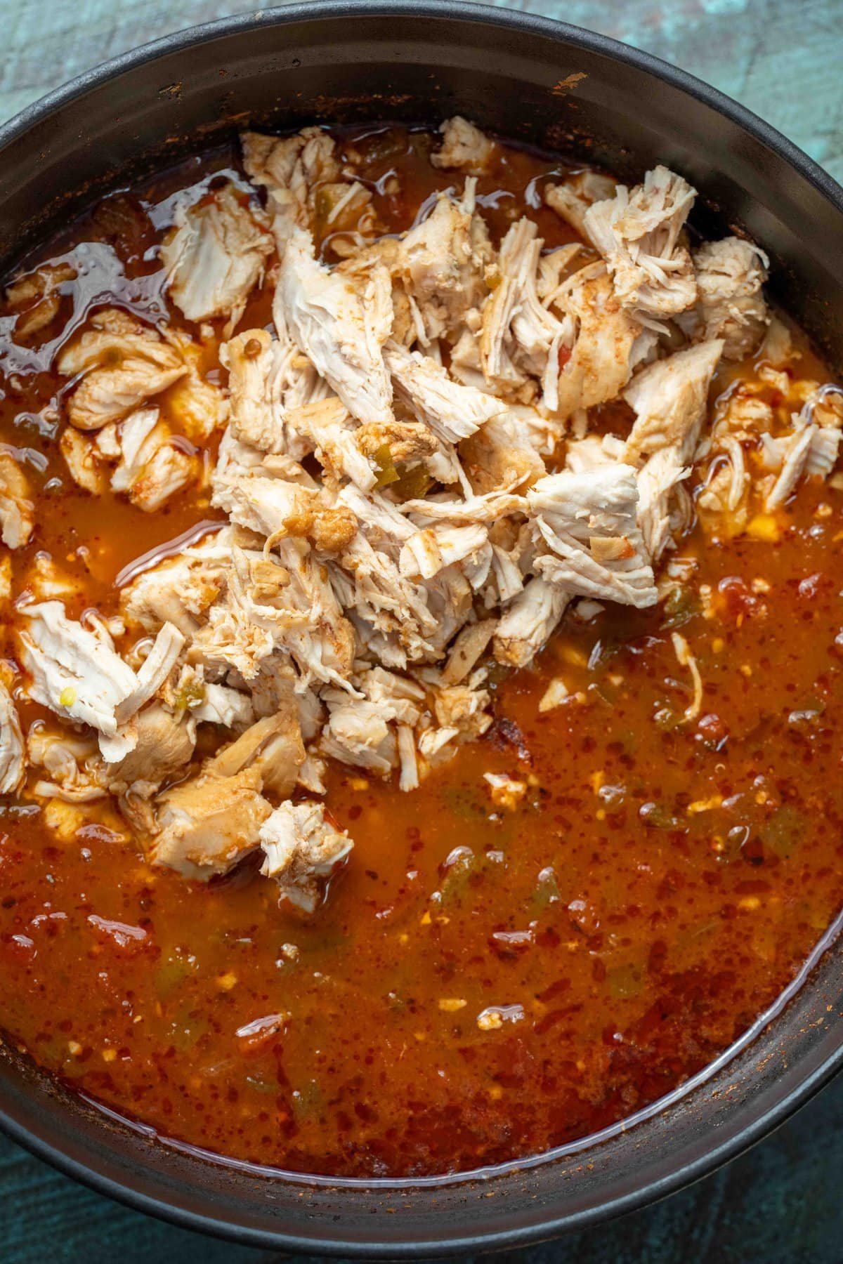 shredded chicken in a spicy adobo soup