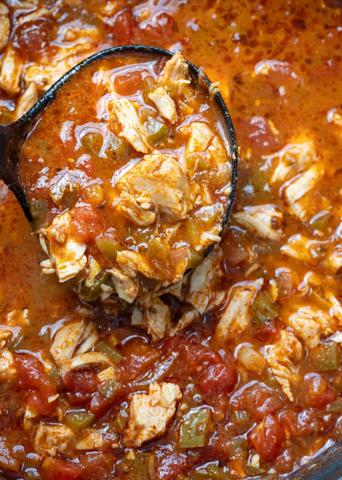 closeup of spicy soup full of chicken and peppers