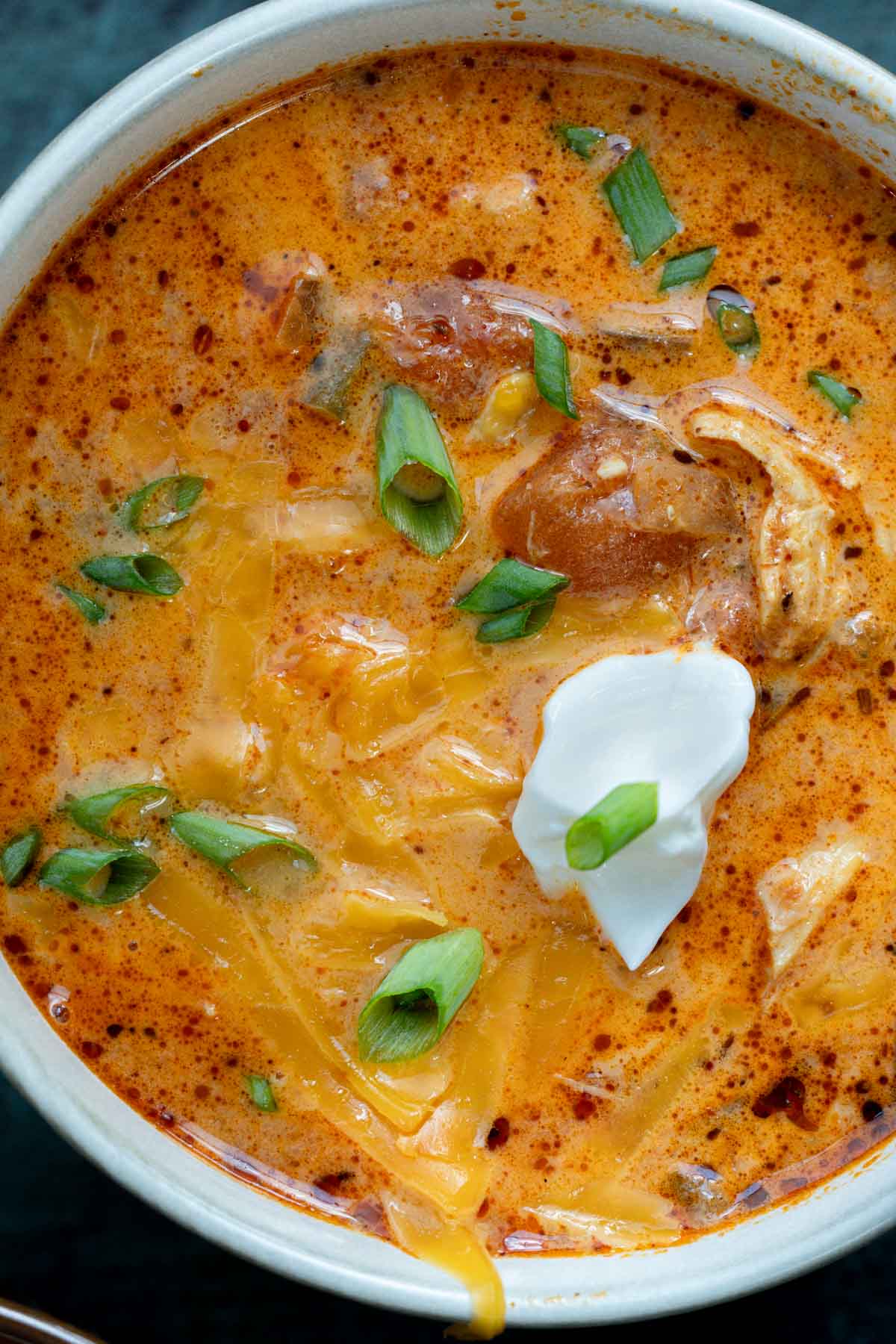 creamy chipotle chicken soup topped with cheese, sour cream, and green onions