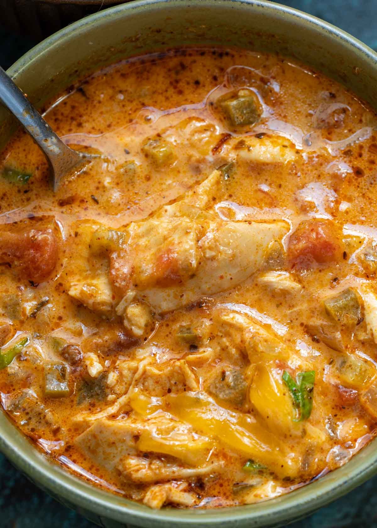closeup of a bowl of creamy chicken soup with peppers and cheese
