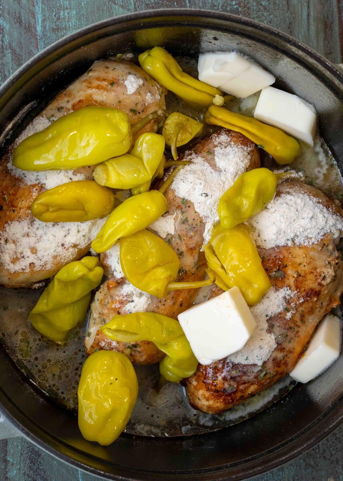 pepperoncini, brine, butter, and ranch seasoning over seared chicken breasts in a dutch oven