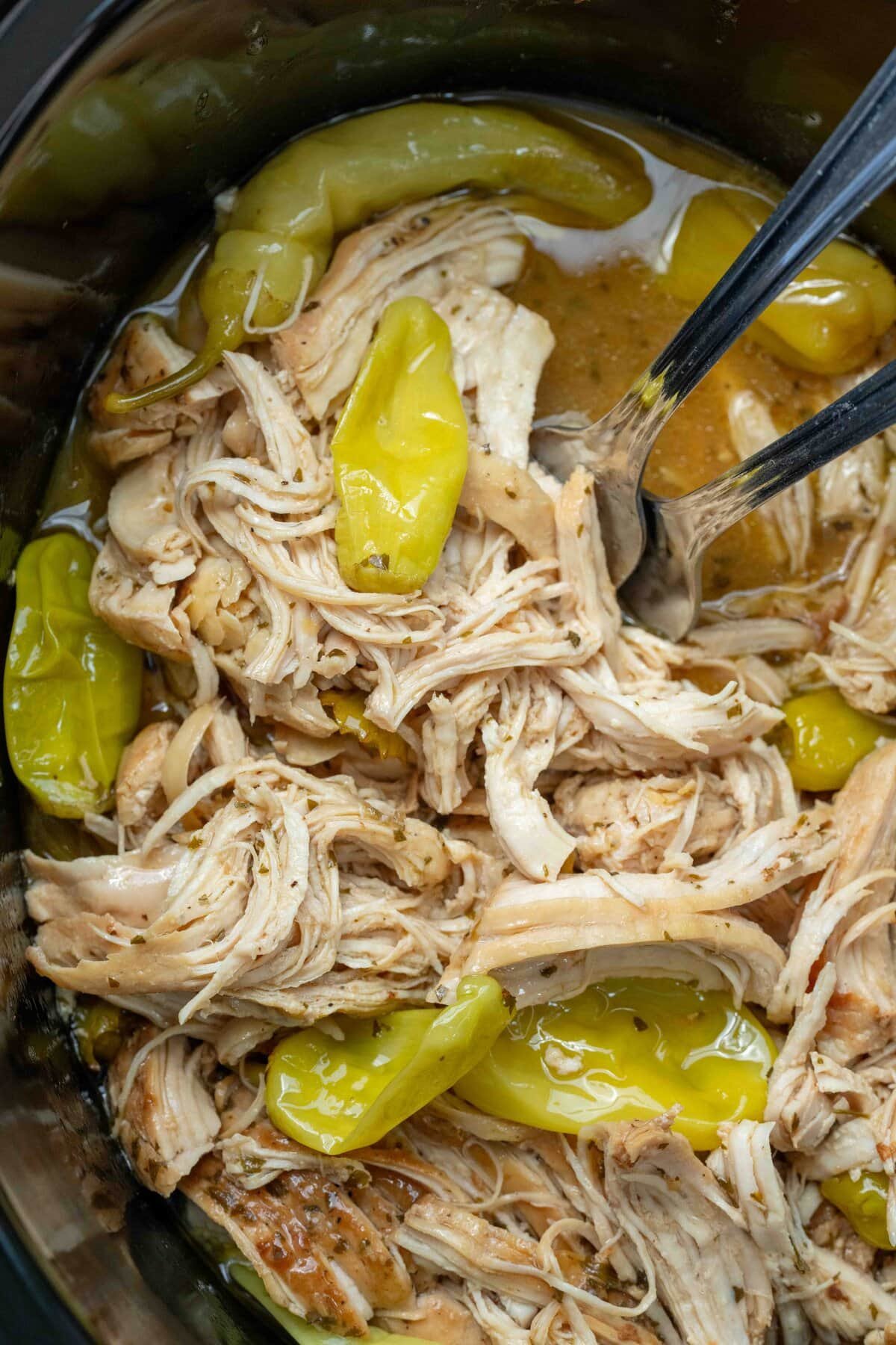 closeup of shredded mississippi chicken in the crockpot