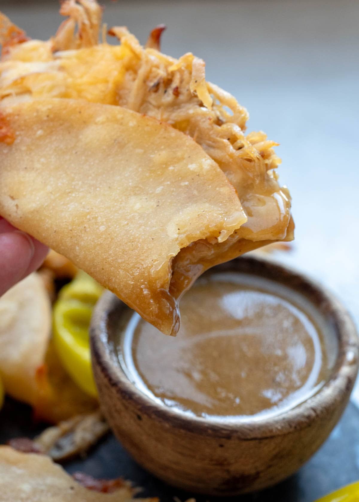 a bite taken out of a juicy baked taco with mississippi chicken sauce