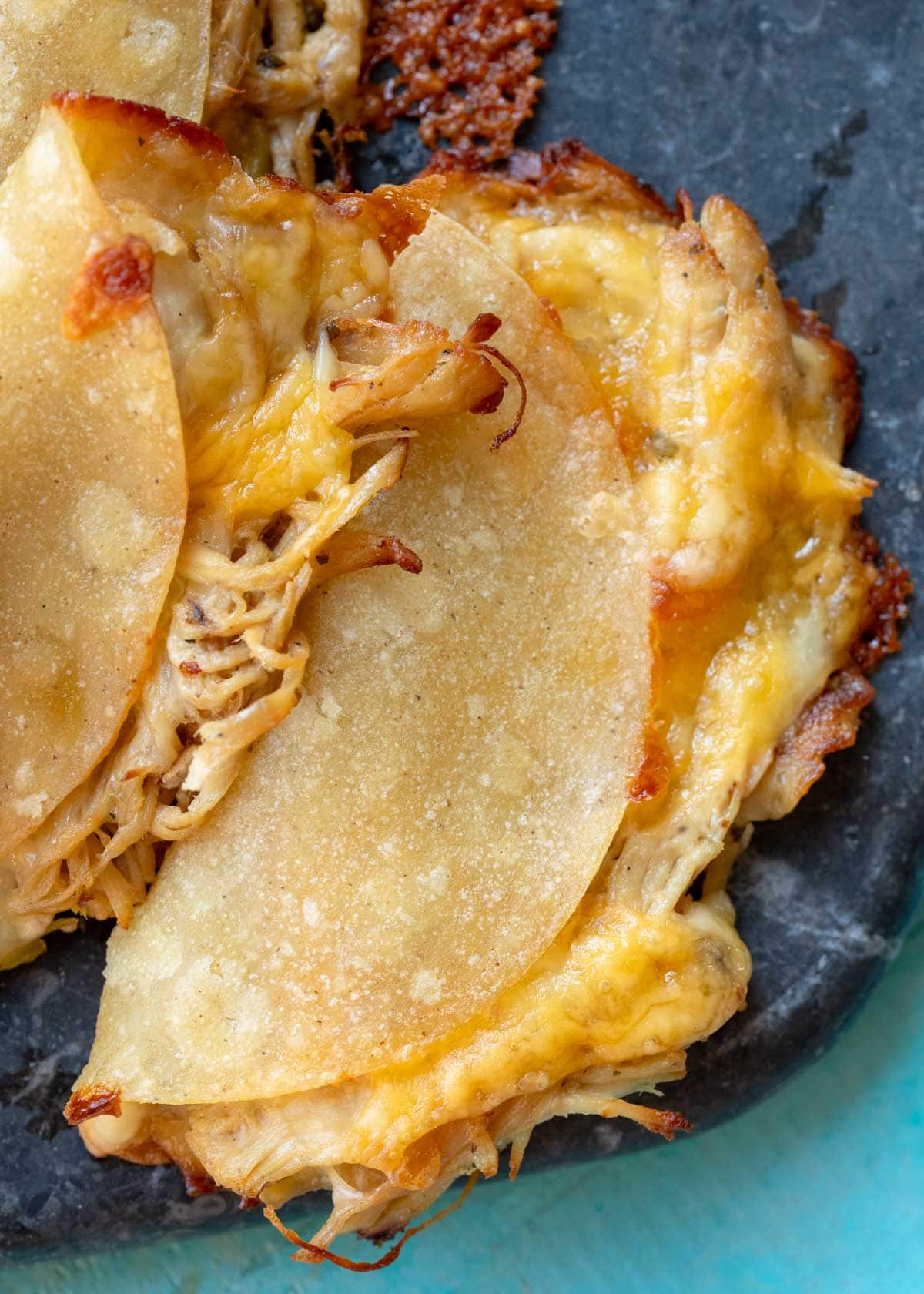 closeup view of super cheesy baked chicken tacos