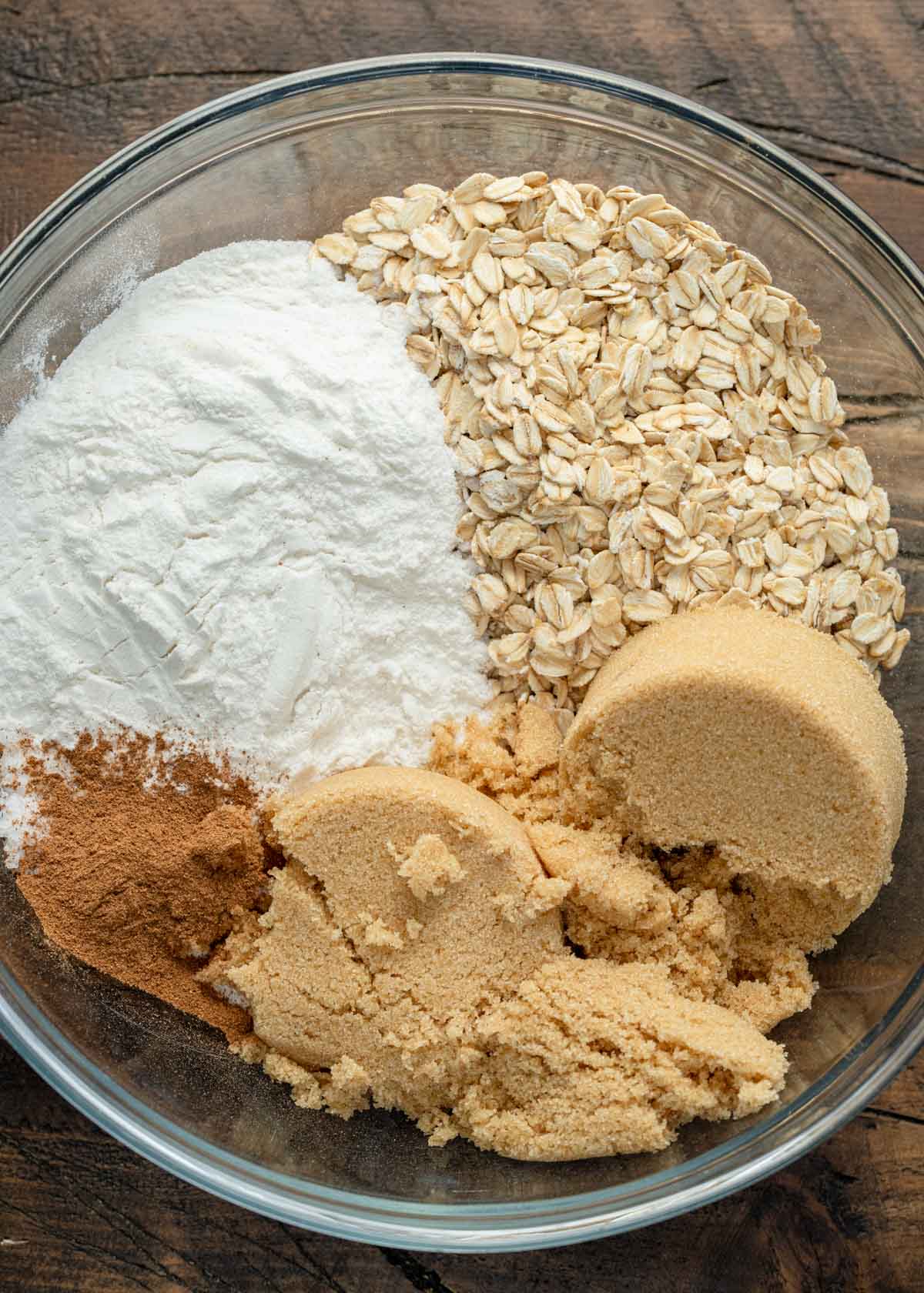 brown sugar, pumpkin pie spice, baking powder, flour, and oats in a bowl