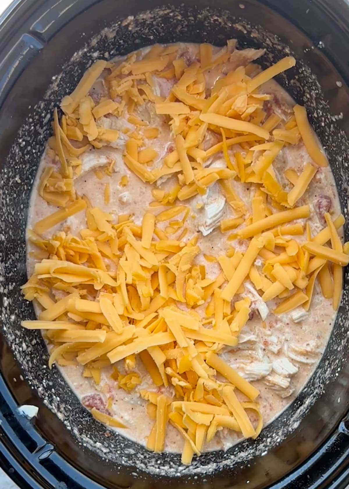 creamy rotel chicken topped with shredded cheese