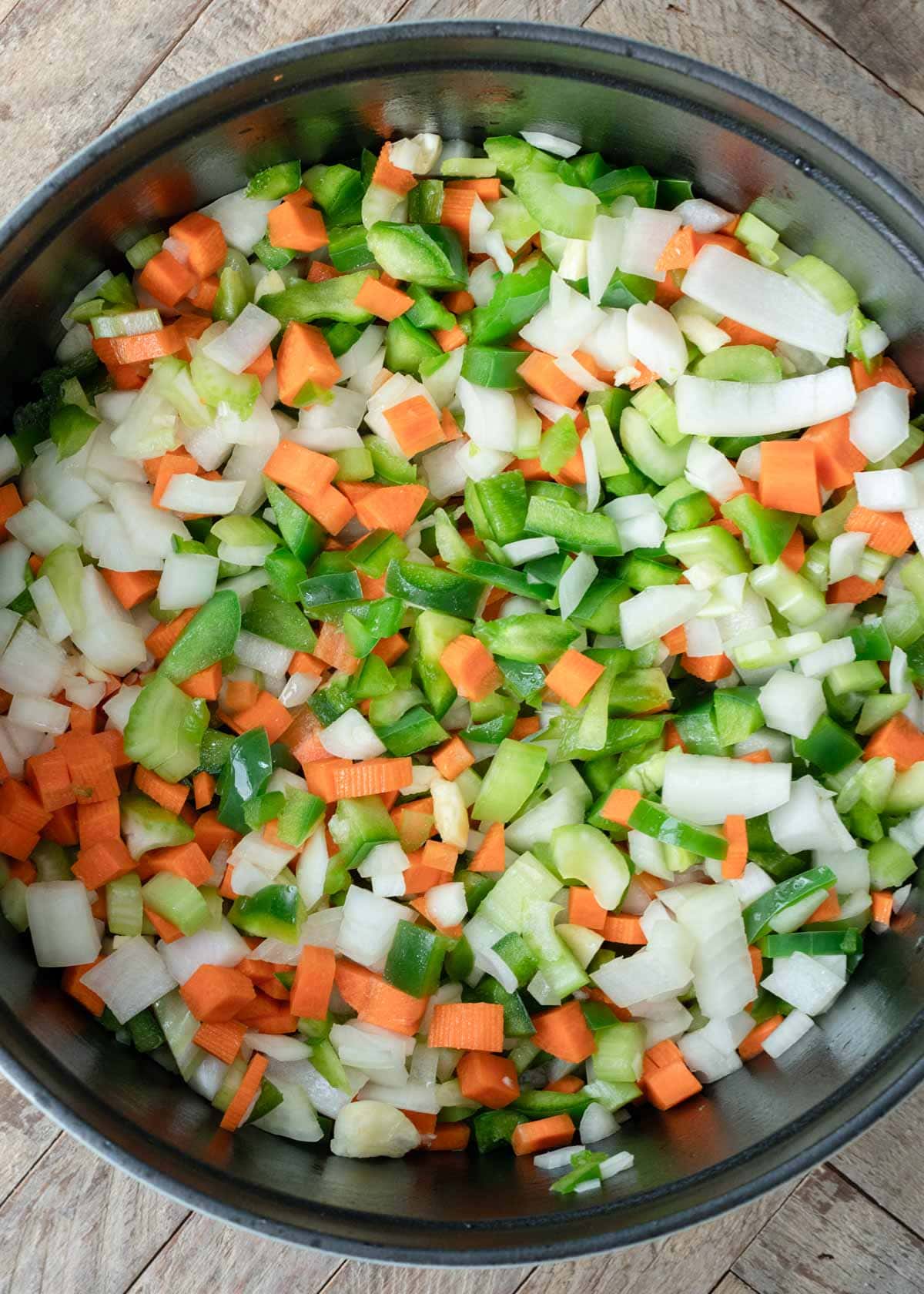 chopped bell pepper, carrots, onion, and garlic in a pot