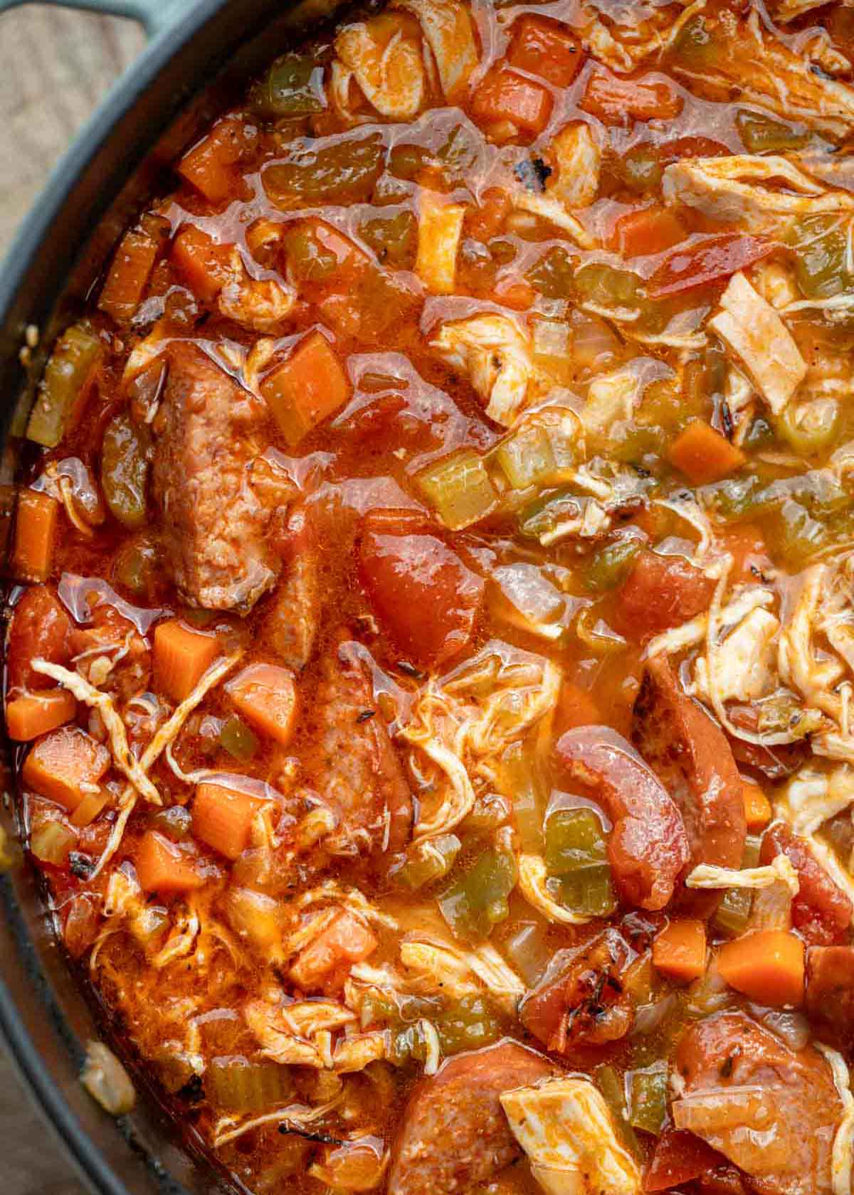 a large dutch oven filled with andouille sausage soup 