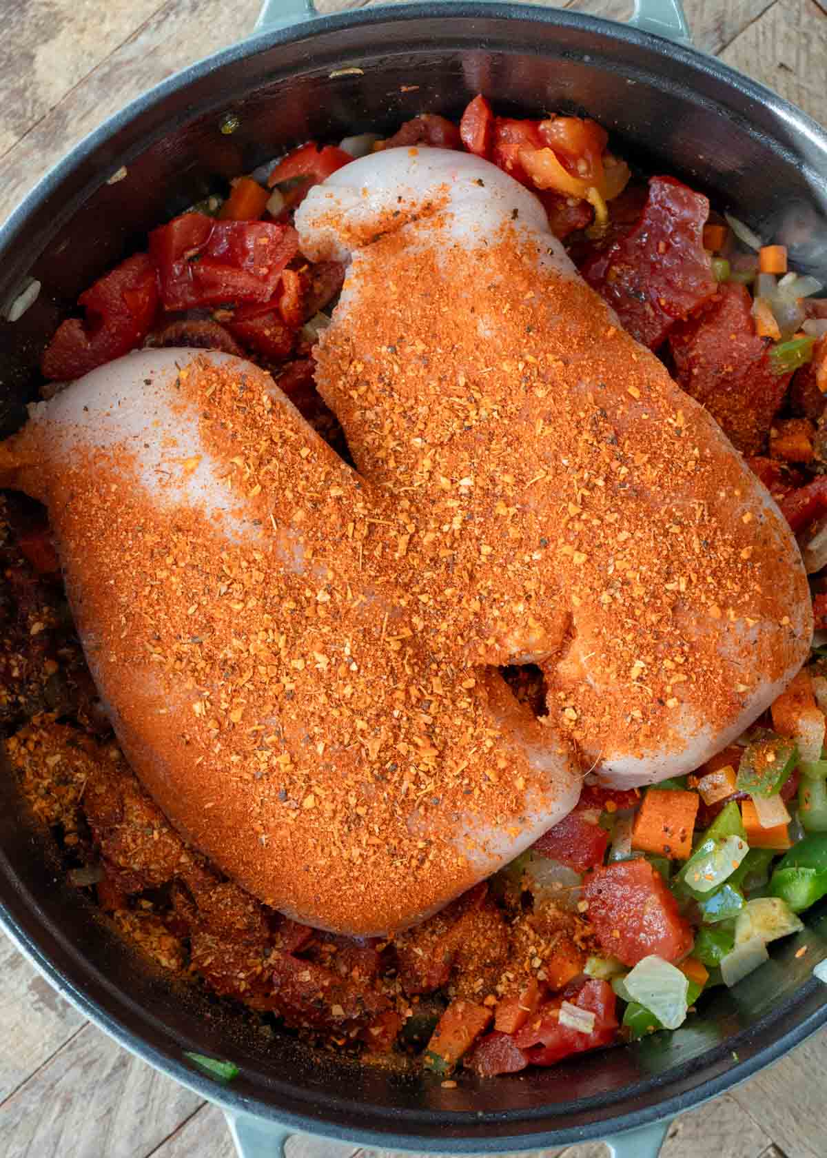 softened veggies, browned sausage, chicken breasts, seasonings, and hot sauce in a large pot