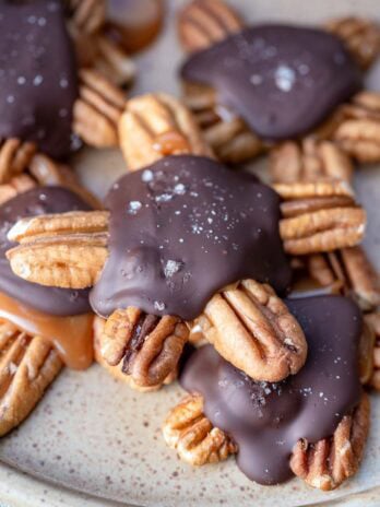 several pecan turtles piled on a plate