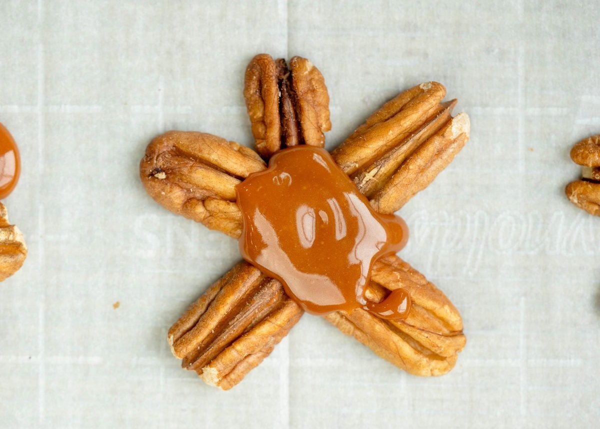 melted caramel spooned onto pecans