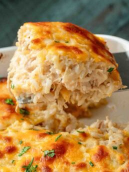 A large, cheesy serving of chicken rice casserole