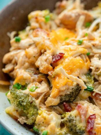 A serving of crack chicken casserole (full of bacon, cheese, ranch, and broccoli) on a plate