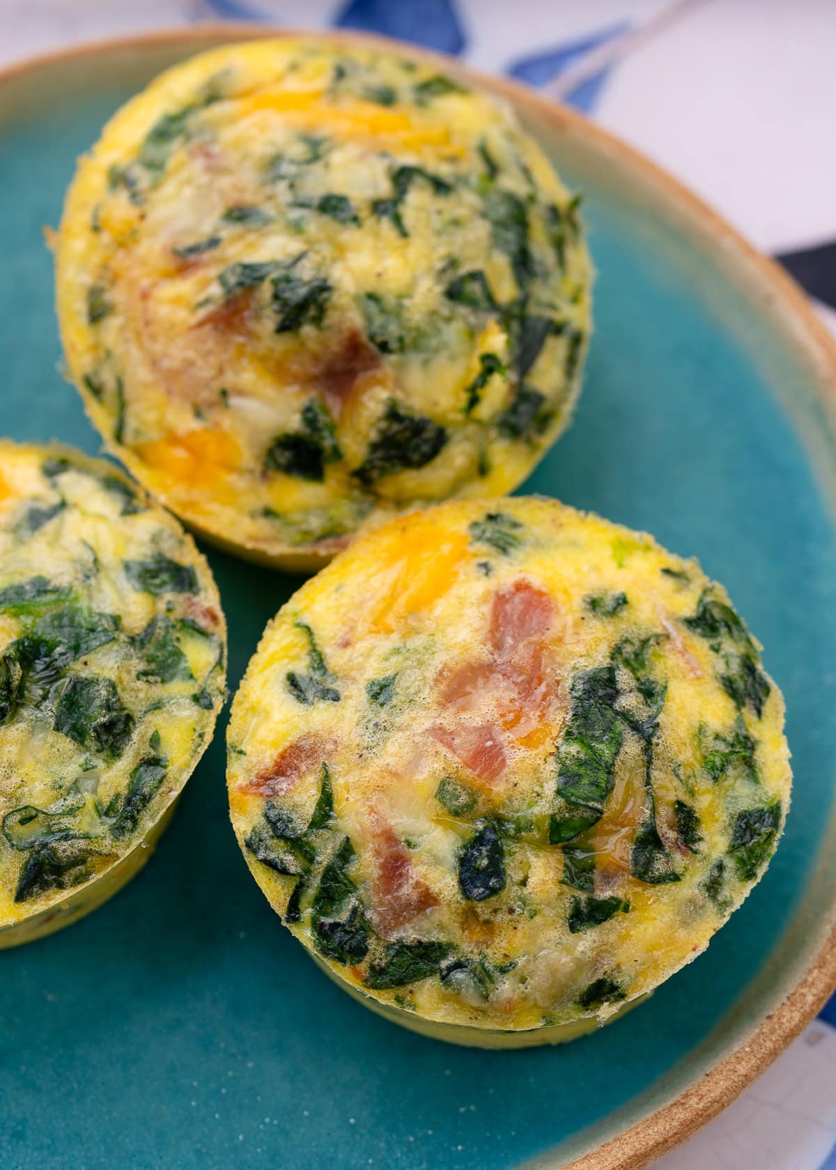 spinach egg bites filled with prosciutto and cheese
