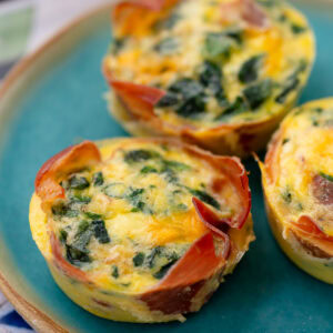 three spinach egg muffins on a plate