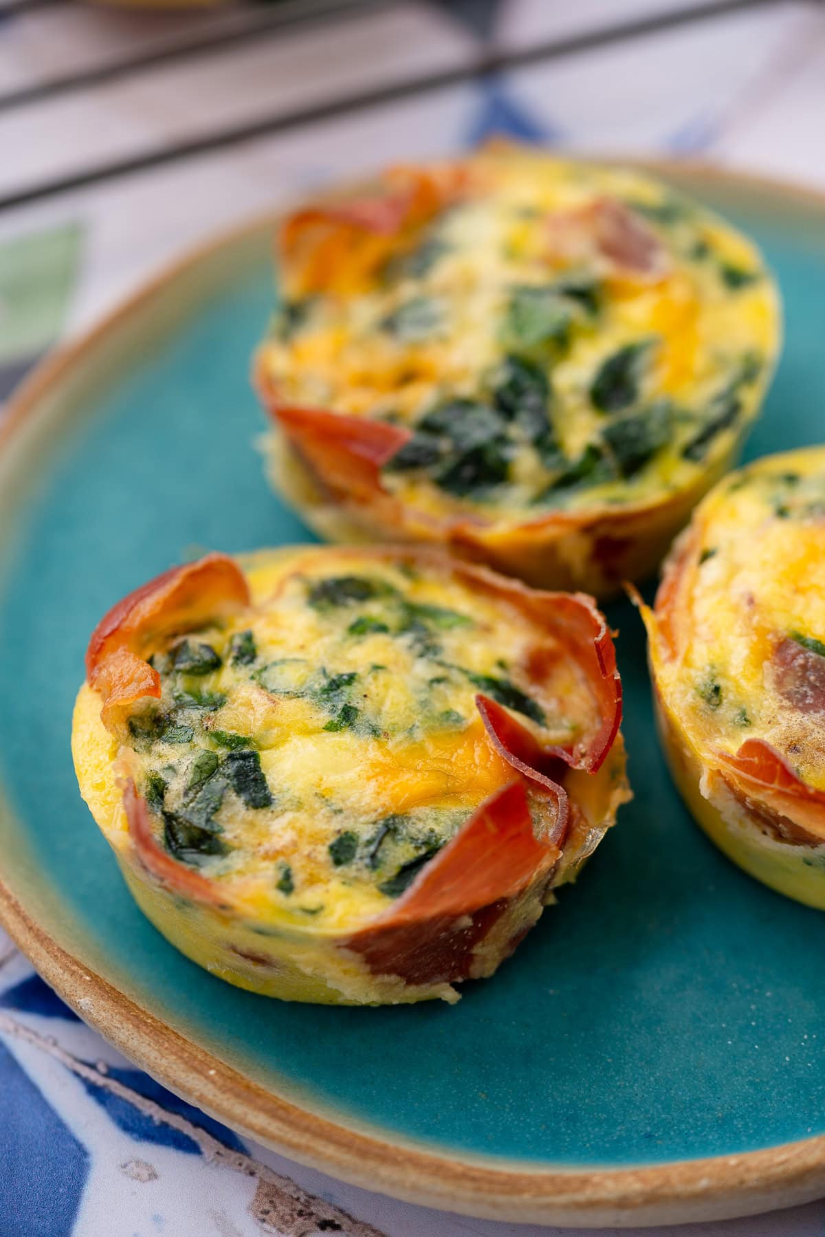 three spinach egg muffins on a plate