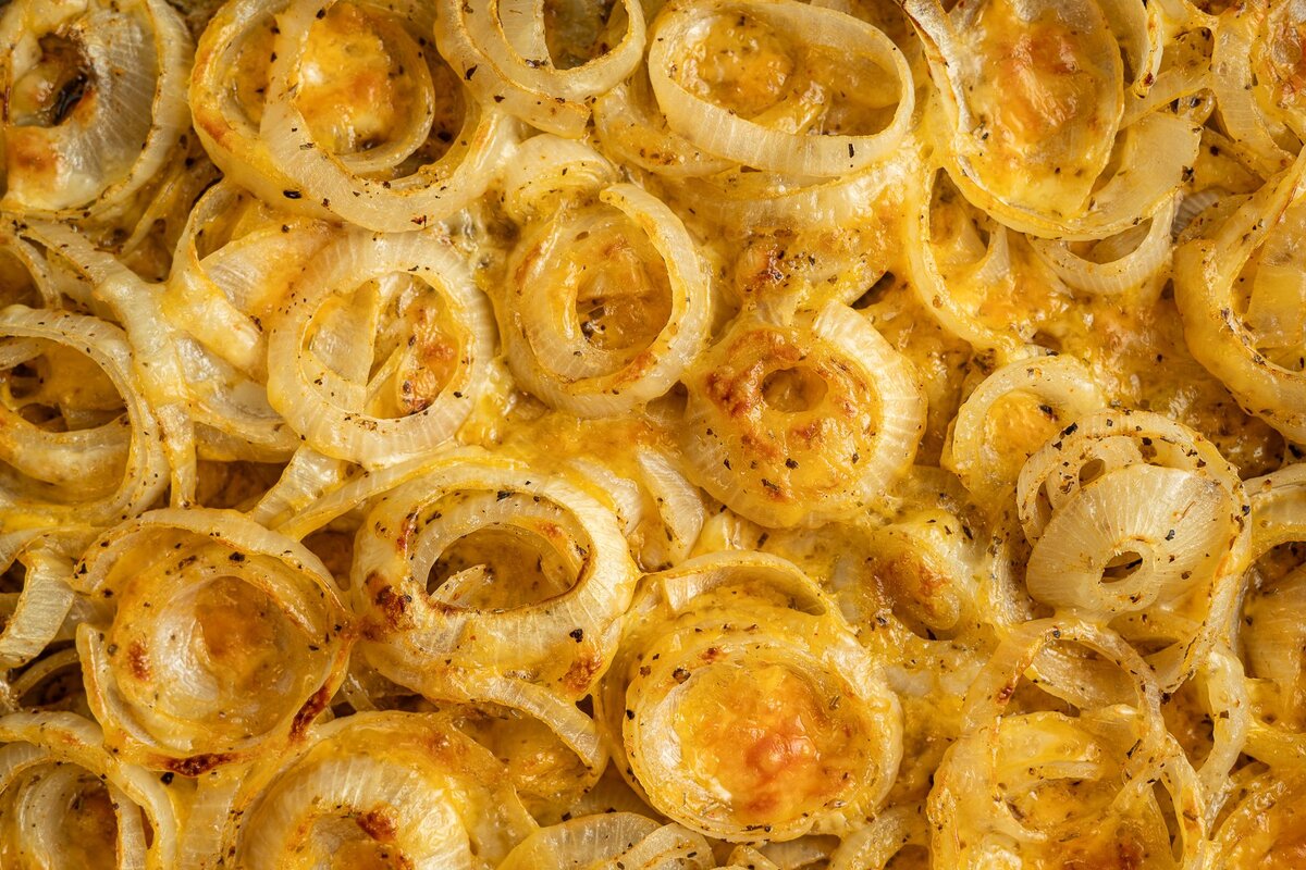 sliced onions roasted until tender, covered in cheesy sauce