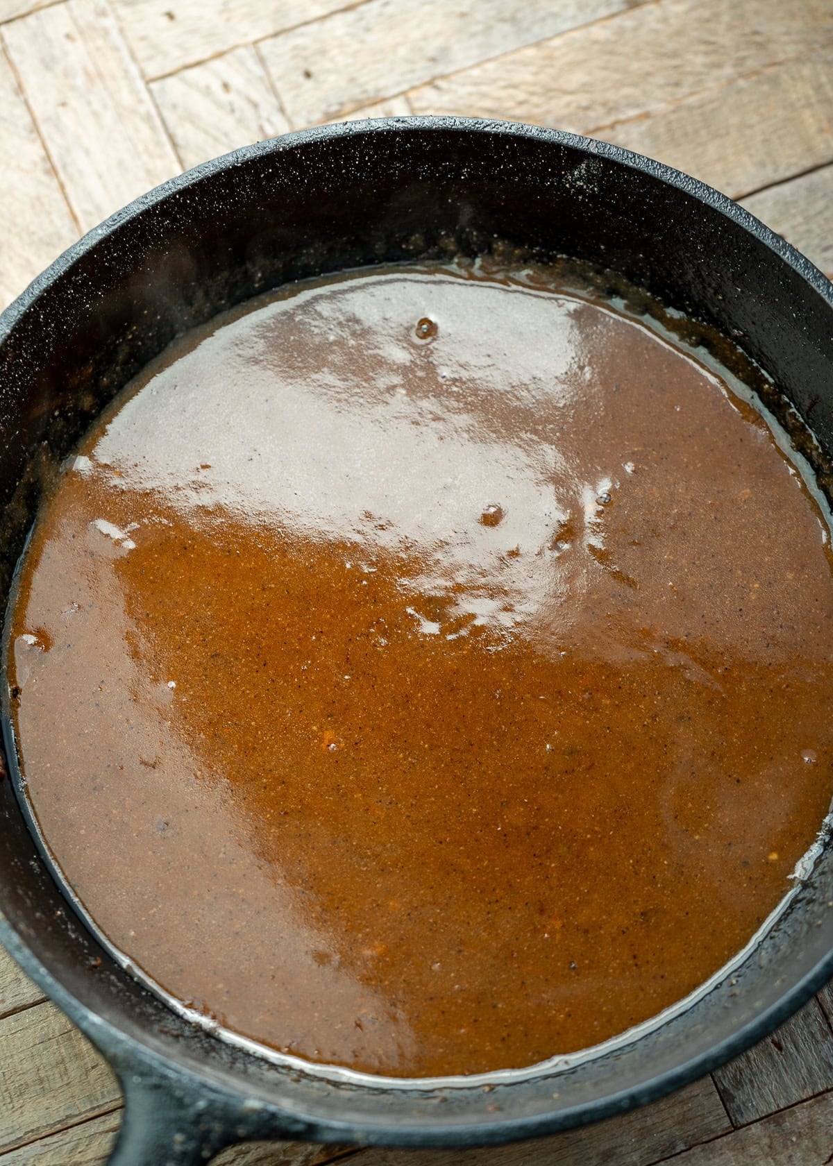 silky smooth chicken gravy in a cast iron skillet