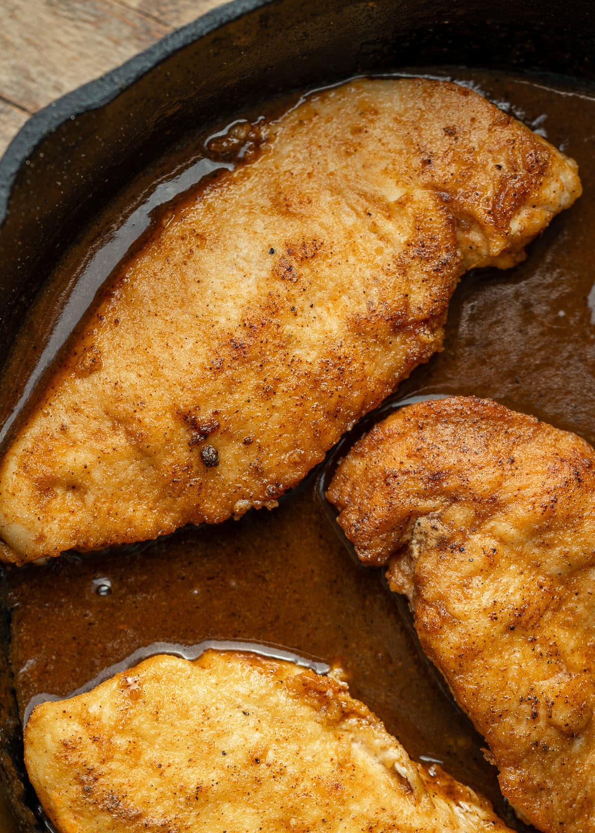 juicy chicken and gravy in a cast iron skillet