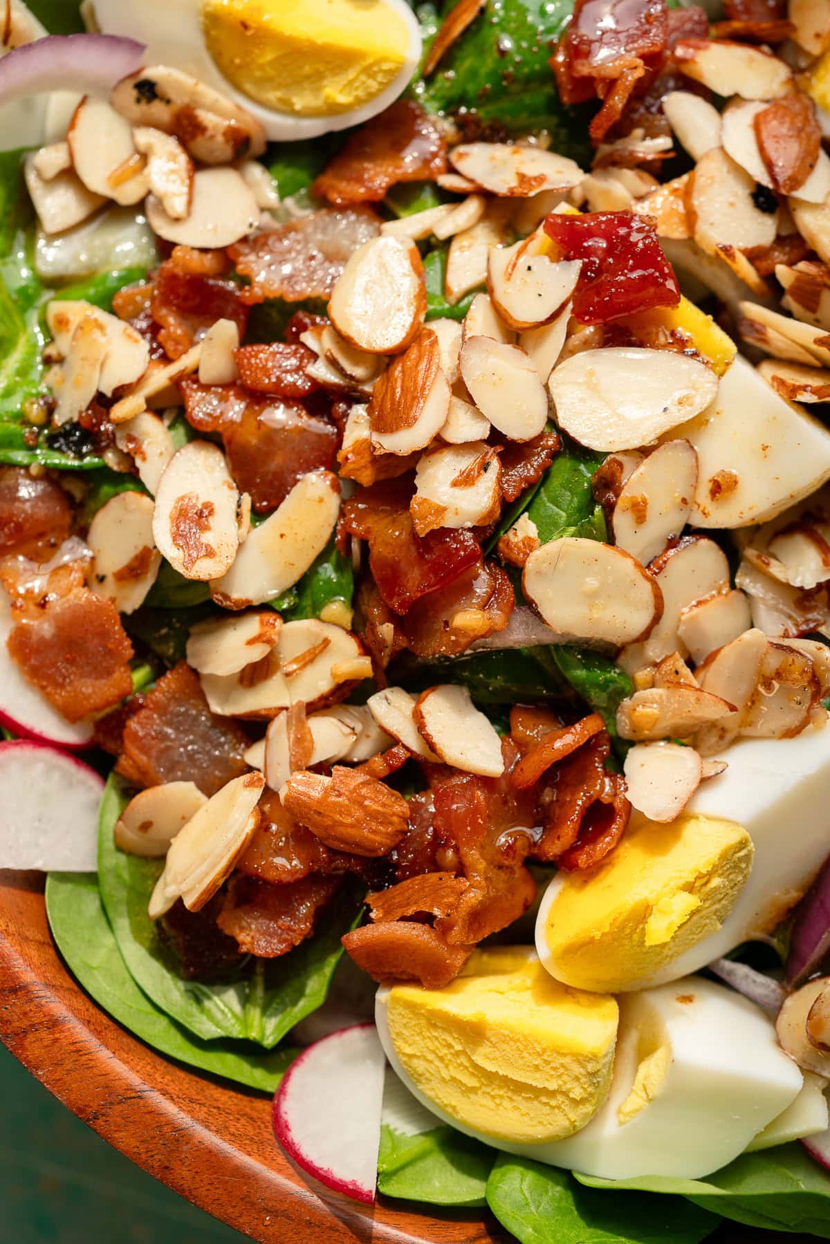 closeup shot showing the easy spinach salad with hot bacon dressing