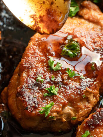 close up, overhead image of white wine sauce being added to top of pork medallions