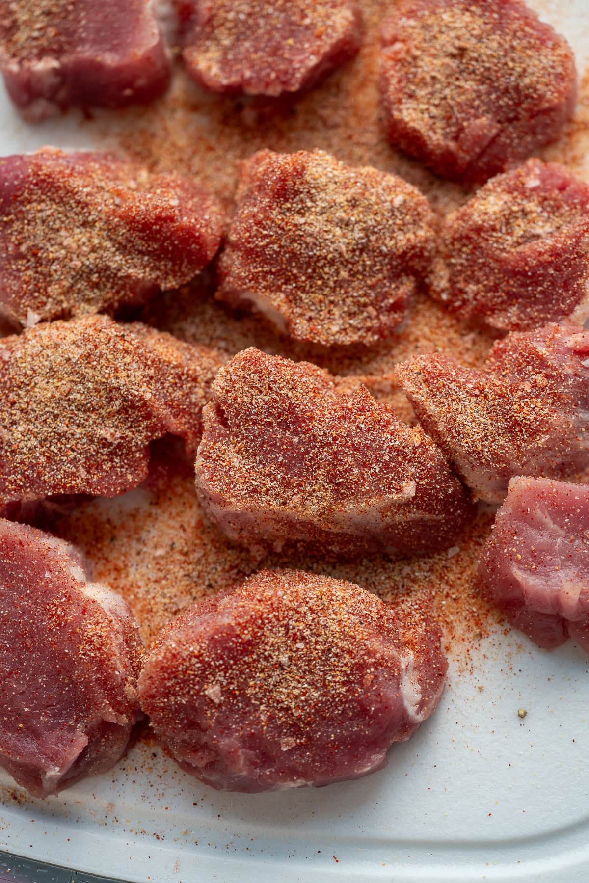 uncooked pork medallions on a cutting board