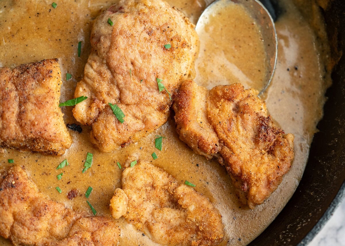 Tender pan fried pork tenderloin in a creamy gravy