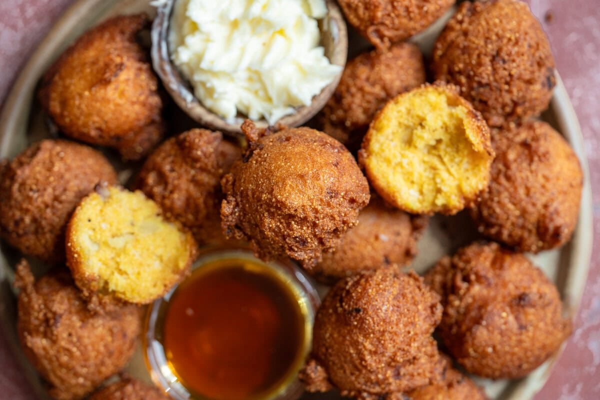 the best southern hush puppies ever with a side of hot honey and whipped butter