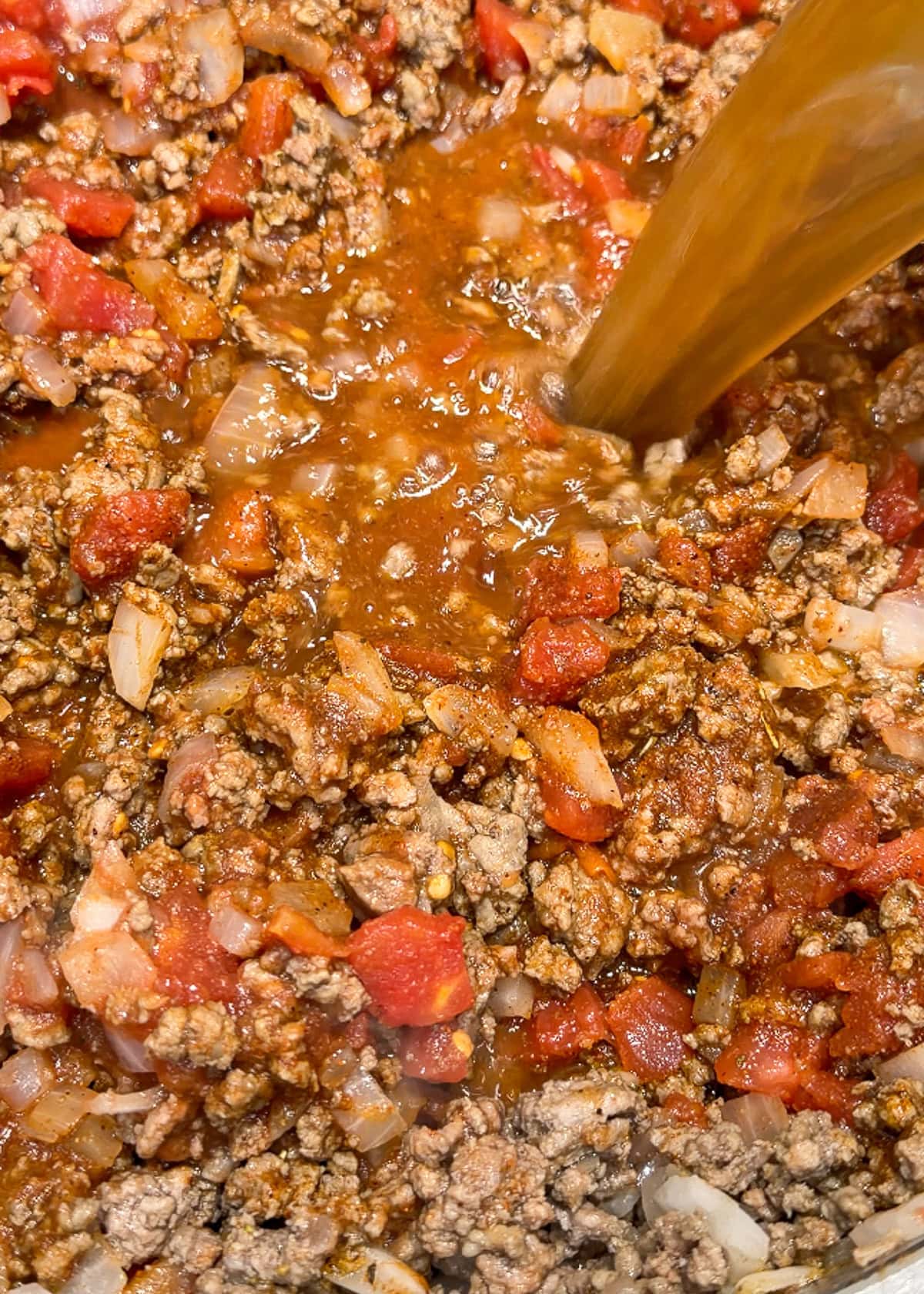 tomato sauce, milk, and broth stirred into ground beef, tomatoes, and seasonings