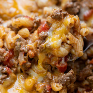 a spoon scooping a cheesy serving of easy, cheesy chili mac