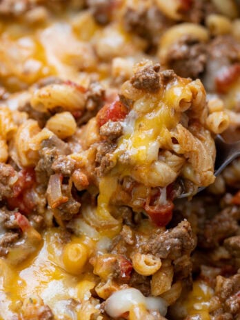 a spoon scooping a cheesy serving of easy, cheesy chili mac